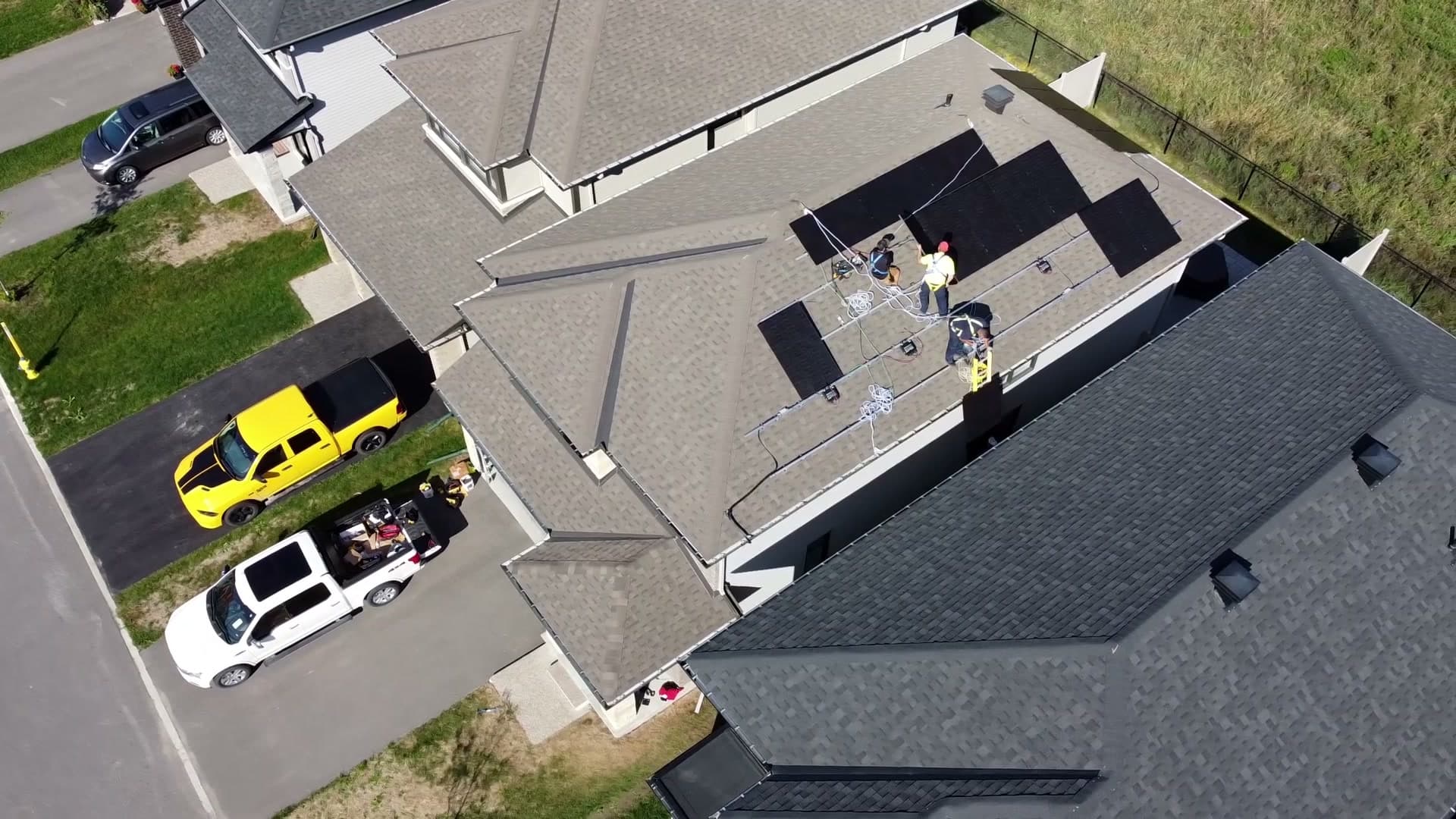 KAJK installers laying racking on an Orléans roof, seen from a drone