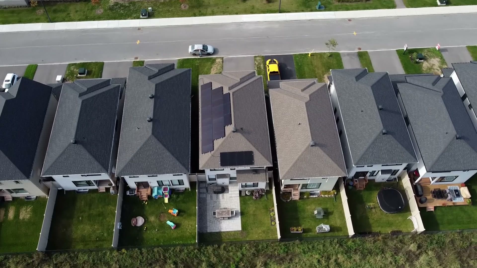 A row of Orléans homes from a drone, one with a new solar array