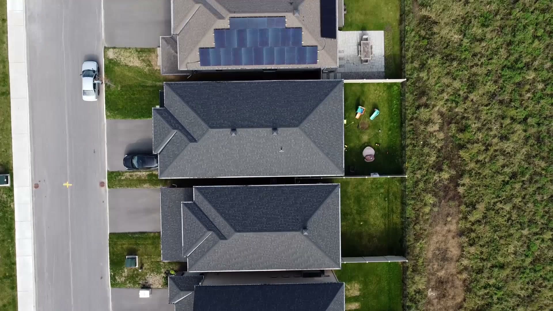 Top-down drone view of a row of Orléans homes, one with solar panels