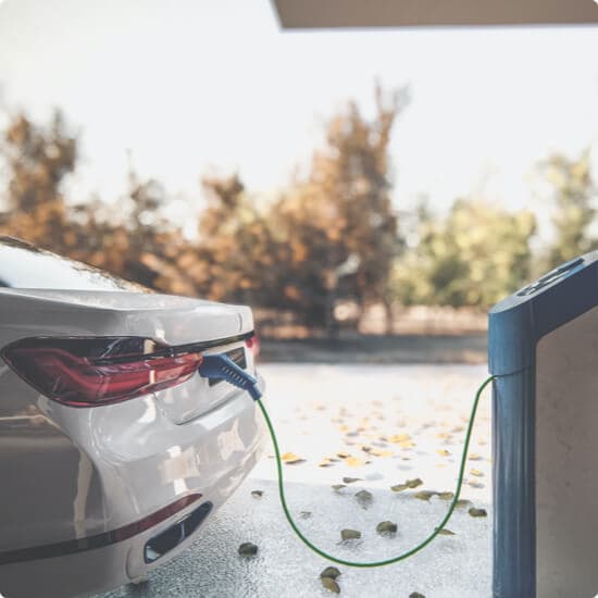 An electric car plugged into a wall charger