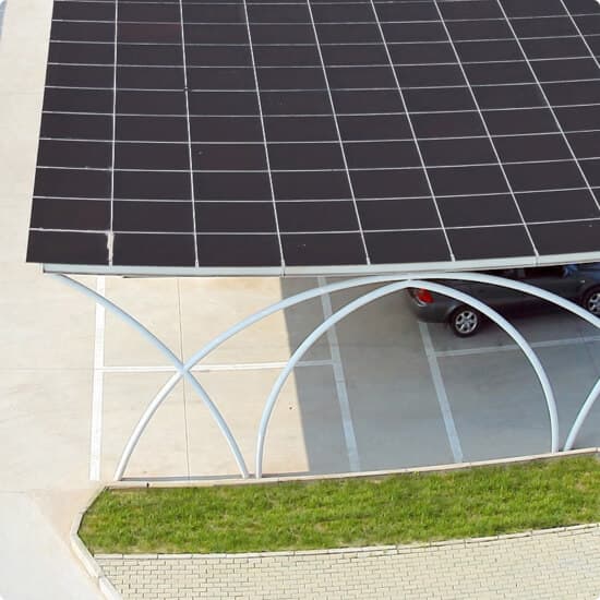 A solar carport over a paved parking space